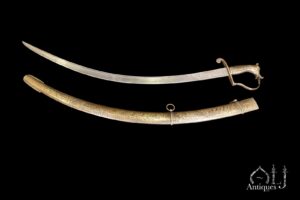 A Rare Engraved and Lac-Inlaid Shamshir with Watered Steel Blade, Silver-Damascened Devotional Inscriptions and Makara-Head Hilt  Probably Lucknow, North India, possibly commissioned for the Deccan or Mysore, Circa 18th Century.