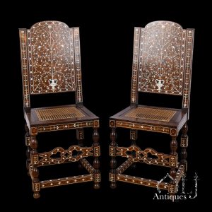 A Rare and Exceptional Pair of Indo-Portuguese High-Back Chairs, Constructed in the Coromandel Coast Tradition and Profusely Inlaid with Natural and Green-Stained Ivory or Bone and Contrasting Woods in the Western Indian Mughal Taste, Probably Coromandel Coast and Western India, Possibly Gujarat, circa 1650–1680